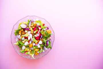 fresh salad on pink background. Mediterranean salad