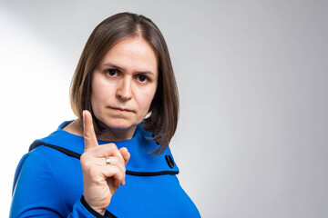 woman gesturing a no sign. Closeup portrait unhappy, serious raising finger up saying oh no you did not do that grey background. Negative emotions facial expressions, feelings