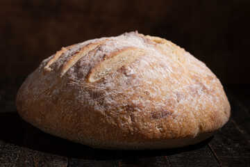 A Loaf of Sour Dough Bread on a Wooden Table
