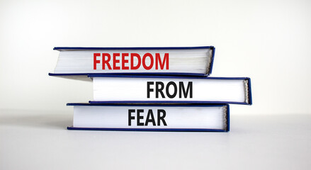 Freedom from fear symbol. Books with words 'freedom from fear'. Beautiful white background, copy space. Business, motivational and freedom from fear concept.