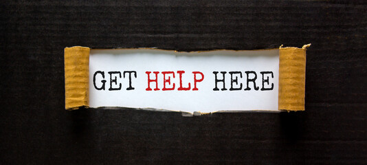 Support and get help here symbol. Words 'get help here' appearing behind torn black paper. Beautiful black background. Business, support and get help here concept. Copy space.