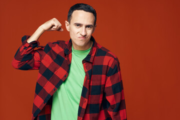 Confident young man in a shirt and in a green T-shirt 