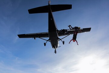 Skydiver jumping from the plane at the sunset.