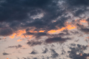 Skyscape cloudscape colorful dark orange blue grey gray sky clouds at evening sunset in Sunny Isles Beach, North Miami, Florida