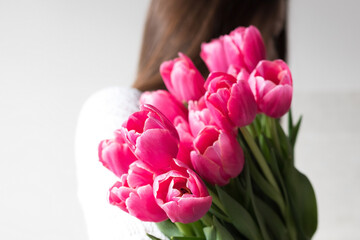 Girl holding a bouquet of tulips, lifestyle photo you can't see the face
