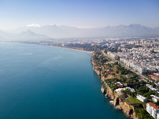 Obraz premium Aerial photograph of Antalya bay in Antalya city from high point of drone fly on sunny day in in Turkey. Amazing aerial cityscape view from birds fly altitude on beautiful town and sea full of yahts