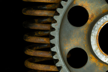 Rusted gear and spring.