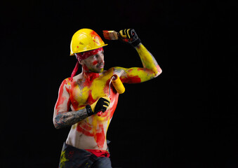 the man is a builder a painter a plasterer all in paint with a brush and a roller