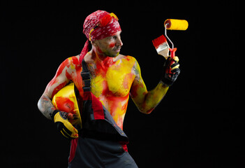 the man is a builder a painter a plasterer all in paint with a brush and a roller