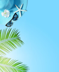 Tropical summer beach background. Palm trees branches, hat with starfish on blue summer background....