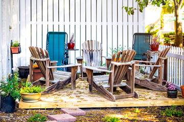 Patio lounge chairs in outdoor garden backyard porch of home with plants, furniture and nobody in South Carolina american home