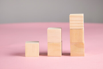 wooden cubes on pink background