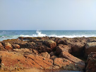 Fototapeta na wymiar rocks in the sea and white waves Visakhapatnam beach