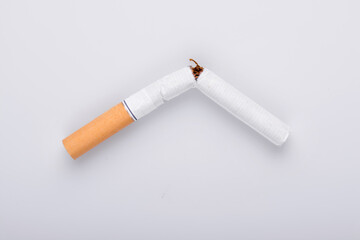 Broken cigarette on white background , World No Tobacco Day Tobacco and lung health concept .