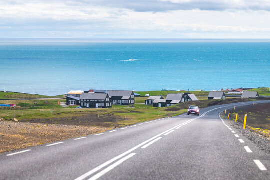Hellnar, Iceland near national park in Snaefellsnes Peninsula with many houses and scenic view of light blue Atlantic ocean water