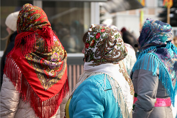 Fototapeta premium Russia, Yelabuga, March 14, 2021: Russian women in colorful headscarves in front of the stage.