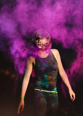 Expressive night woman portrait with colorful holi powder. Holi colour splash