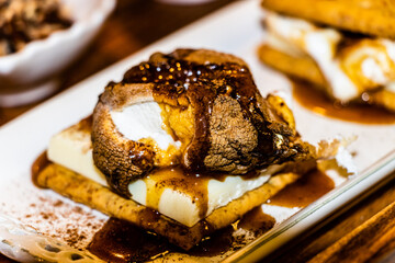 White chocolate and marshmallow  graham cracker smore covered in birch whiskey toffee sauce
