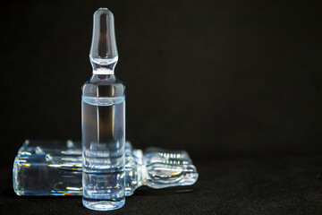 Glass medical ampoule vial for injection. Medicine is liquid sodium chloride with of aqueous...