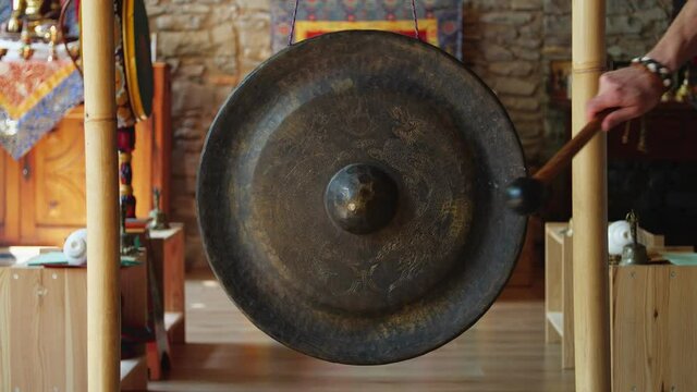 Static shot of miniature gong in focus with shallow depth of field.