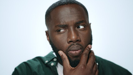 Portrait of african american man thinking idea on light background in studio.