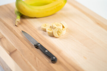 Bananas on wooden cutting board