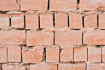 Texture of brick wall. Samples of wall or fence are presented at exhibitions. Orange brick close up.
