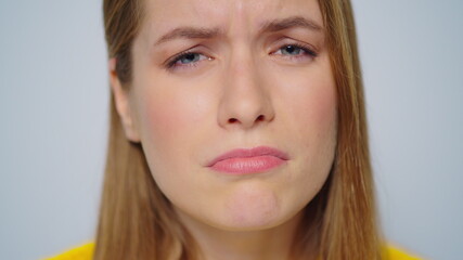 Portrait of doubtful woman waving head in studio. Critical girl feeling upset.