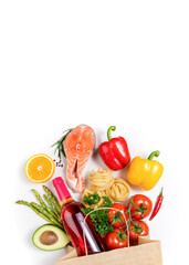 Healthy food background. Healthy food in paper bag fish, vegetables and fruits, wine on white. Shopping food supermarket concept. Healthy eating concept with copy space