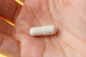 White pills and tablets in the woman. Macrophotography. Close-up. Medicine concept. Minimalistic...