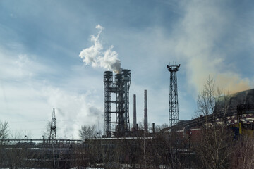 Fototapeta na wymiar Pollution by pipes of industrial enterprises and factories. Industrial chimneys urban landscape power plants pollution steam landscape.the concept of environmental pollution