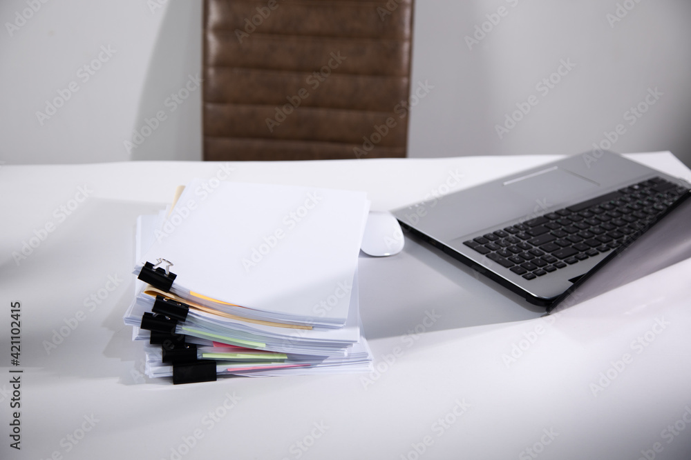 Poster computer and stack of documents