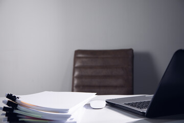 computer and stack of documents