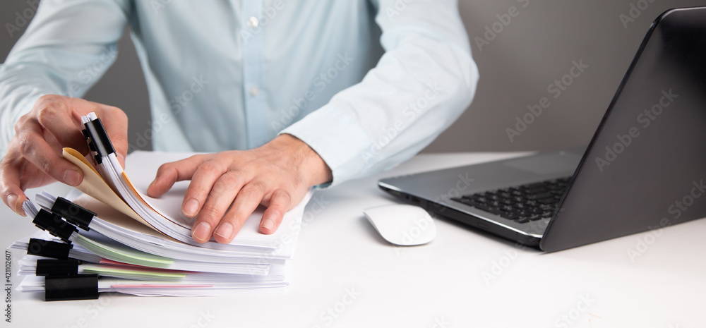 Aufkleber man working computer and stack of documents