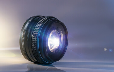 photo lens on white background with reflection and light beam
