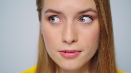 Naklejka premium Closeup young attractive woman showing silence sign on grey background. 