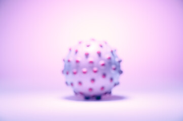 Blurred concept image of the coronavirus on the pink background, tinted in light pink