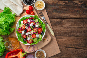 Salad with fresh vegetables and herbs on a brown background.