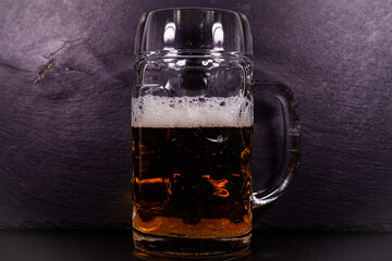 glass of beer on wooden background