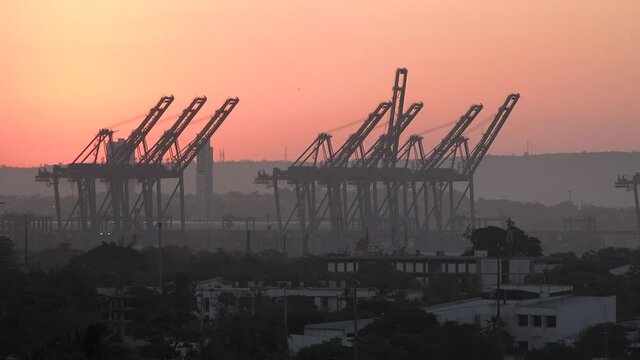 Seaport. Port Cranes and docking facility. Industrial manufacturing facility with cranes and ships in docks.
