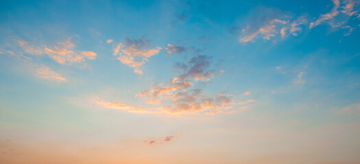 Sunrise clear blue sky with glowing pink clouds at sunset.Blue orange cloudscape