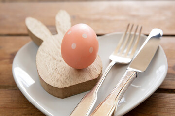Easter meal table decorated with springtime easter bunny and easter eggs