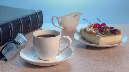 a cup of strong black coffee and a piece of delicious homemade cake on a plate on a wooden table