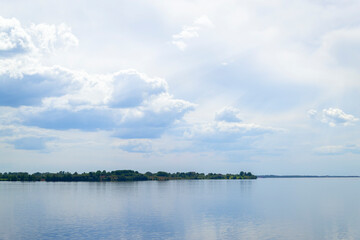The wide river Daugava near the town of Salaspils in Latvia. Beautiful morning landscape. Picturesque view with beautiful clouds.