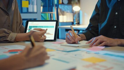 Close-up asia business people meeting plan analysis statistics brainstorm and header of team hold tablet pointing graph chart and employee take note. Finance strategy statistics success concept. - Powered by Adobe