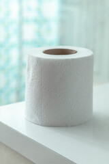 detail of a roll of soft white toilet paper, with white background in studio