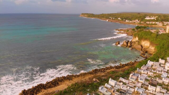 Aerial view of a  beach cemetery with a pirate style, by drone during the sunset. Anse-Bertrand, Guadeloupe