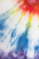 Pastel tie dye, a handmade pattern on a cotton t-shirt. Close-up, top view. DIY concept, handicrafts, original everyday clothes, fabric dyeing techniques. Flat lay, Vertical. Abstract background
