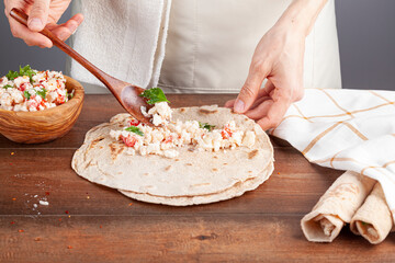 Sikma is a traditional Turkish wrap in mediterranean coast of silifke, mersin. Flat bread known as bazlama is laid and filled with mixture of cheese, tomato and herbs and rolled around tightly.