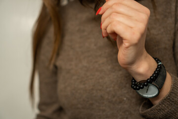 female hand with bracelet and watch 